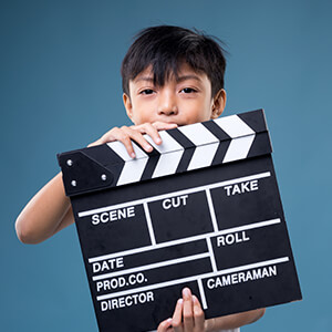 boy with a movie making clapper board