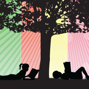 girl and boy reading by a tree